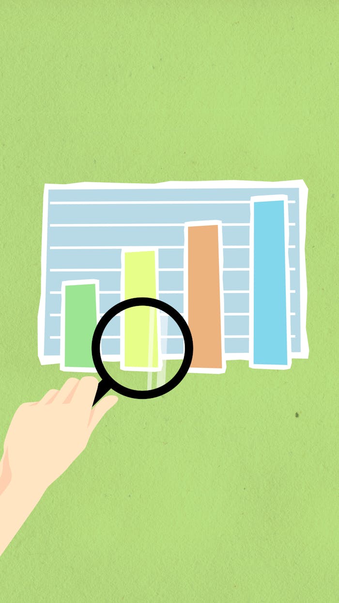 services-04 Top view of decorative cardboard illustration of hand with magnifying glass above diagram with columns on green background